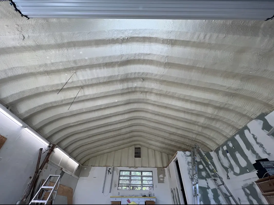 Spray polyurethane foam applied to the underside of a metal roof deck in Elwood